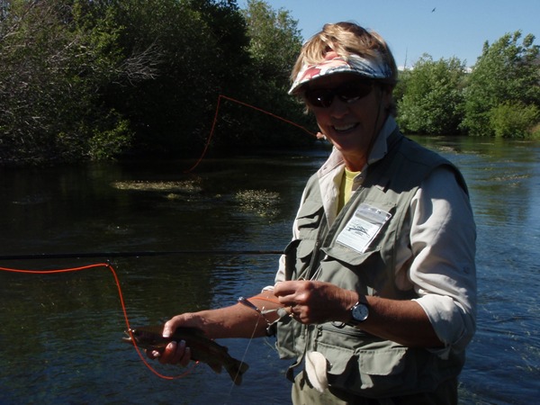 Addie with a big fish on a small stream