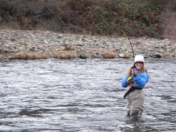 Kelly playing her first spey rod fish