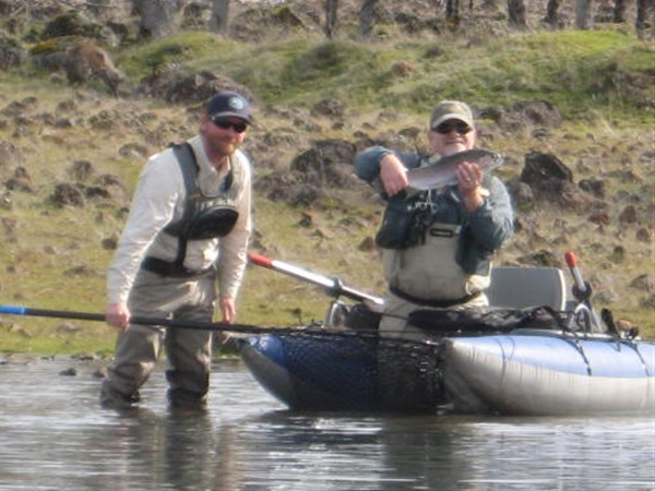 Clint helping Doug land a fish