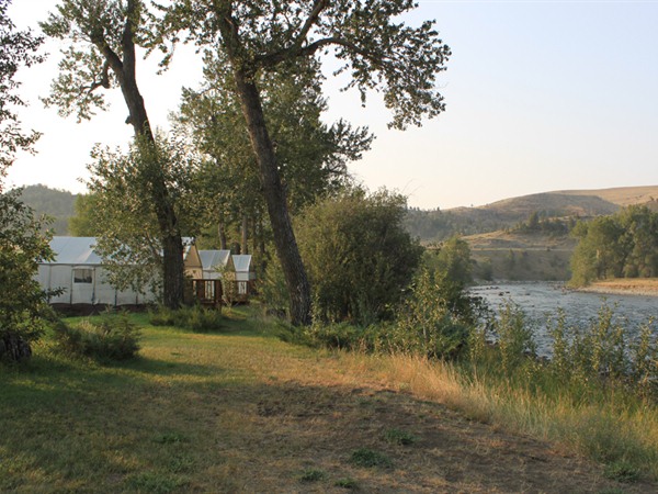 A view of the three tent cabins right by the river
