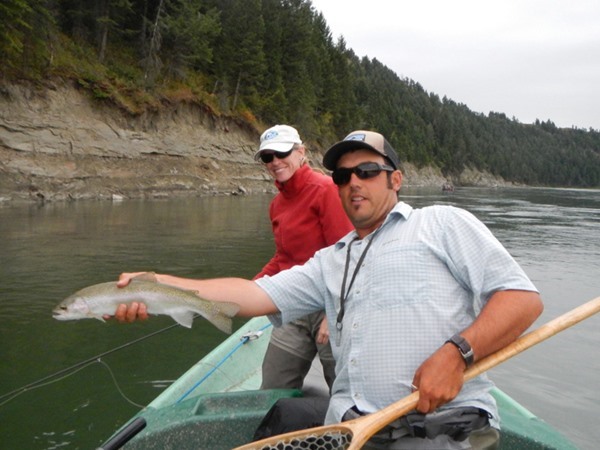 Guide Jason Eggleton holding a Rainbow caught by Katie