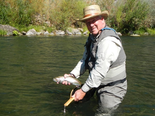 Scott with a rainbow caught on a red copper john