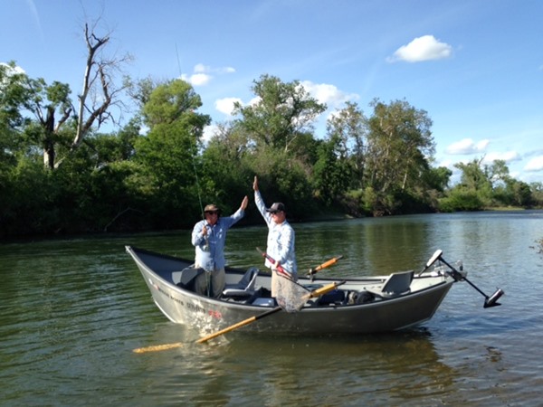 John and guide Mike Folden celebrate a fish in the net