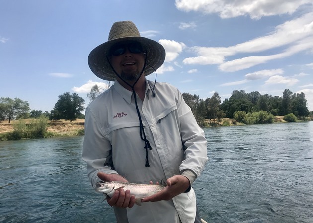 Brandon with his first fish on the fly