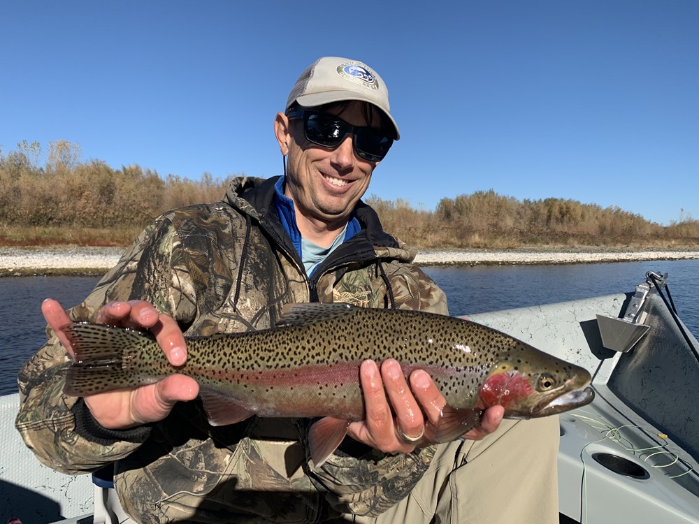 Andrew with a fin-clipped steelhead on the Sac