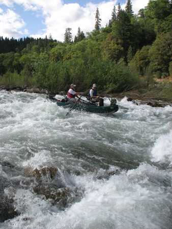 Gino and Adam cruising through a big rapid.