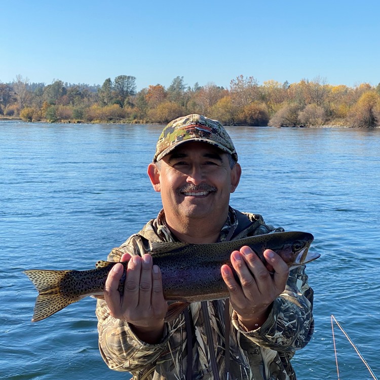 Julian with his first trout on a fly!